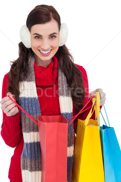 Brunette in winter clothes holding shopping bags Stock photo © wavebreak_media