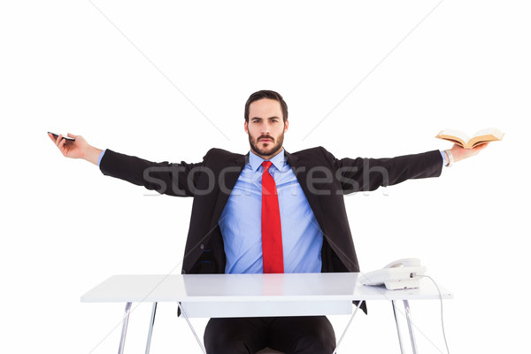 Unsmiling businessman sitting with arms outstretched Stock photo © wavebreak_media