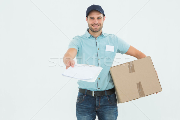 Delivery man with package giving clipboard for signature Stock photo © wavebreak_media