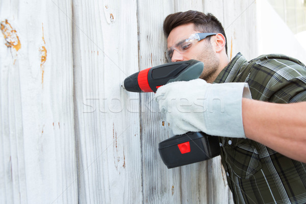 Carpenter drilling wooden cabin Stock photo © wavebreak_media