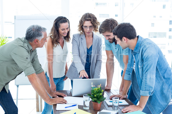 Stock photo: Casual colleagues using laptop in the office
