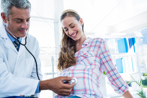 Doctor examining a pregnant woman with a stethoscope Stock photo © wavebreak_media