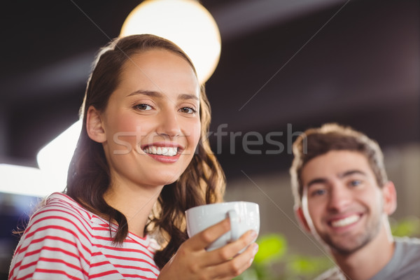 Smiling friends enjoying coffee together Stock photo © wavebreak_media