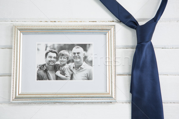 Close up of picture frame hanging by necktie on wall Stock photo © wavebreak_media