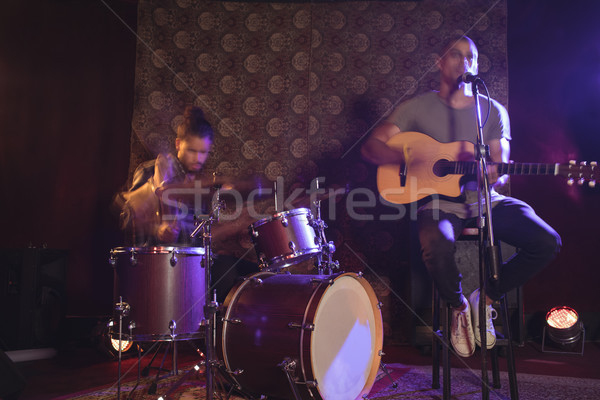 Male singer performing with drummer in nightclub Stock photo © wavebreak_media