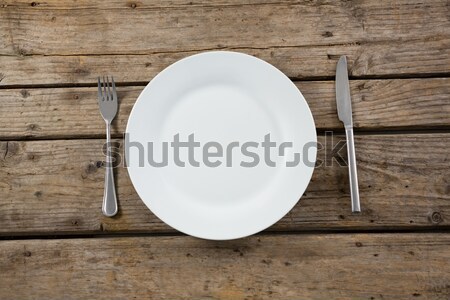 Stock photo: Overhead view of empty plate with cutlery