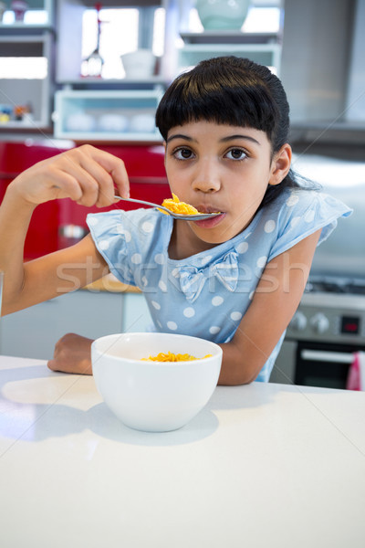 Portrait of girl eating breakfast in kitchen Stock photo © wavebreak_media