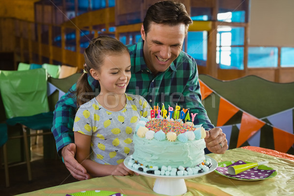 Stock photo: Father and daughter with birthday cake