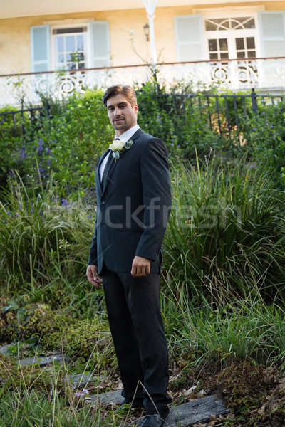 Portrait of handsome bride standing by plants in park Stock photo © wavebreak_media