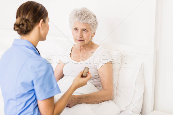 Nurse taking care of suffering senior patient  Stock photo © wavebreak_media