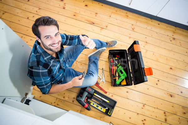 Man fixing kitchen sink giving thumbs up Stock photo © wavebreak_media