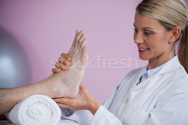 Physiotherapist giving foot massage to a patient Stock photo © wavebreak_media