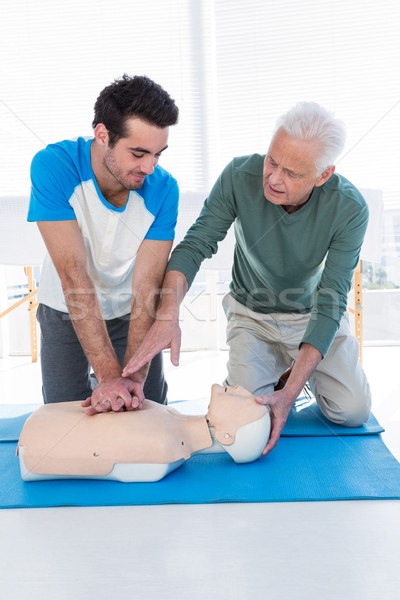 Paramedic training cardiopulmonary resuscitation to man Stock photo © wavebreak_media