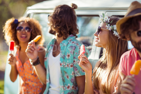 Group of friends enjoying and eating ice lolly Stock photo © wavebreak_media