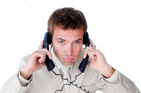 Annoyed businessman tangle up in phone wires  Stock photo © wavebreak_media