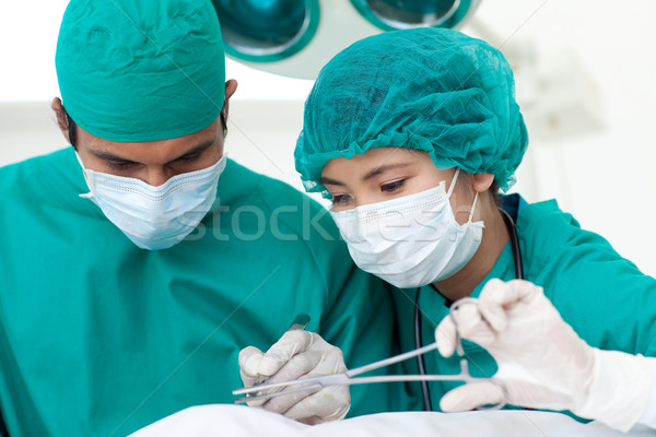 Portrait of two ethnic surgeons in operative room Stock photo © wavebreak_media