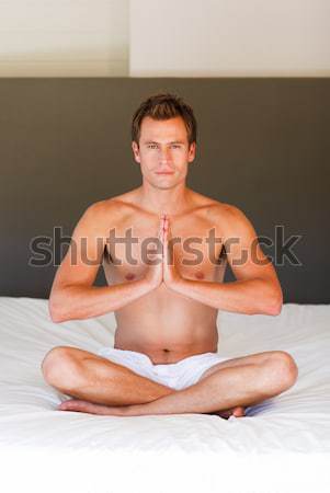 Young couple on budha position on bed Stock photo © wavebreak_media