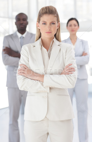Delighted businesswoman standing at the camera with arms folded  in a office Stock photo © wavebreak_media