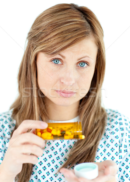 Stock photo: Diseased woman taking pills against a whie background 