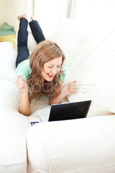 Hevesli kafkas kadın bakıyor dizüstü bilgisayar kanepe Stok fotoğraf © wavebreak_media