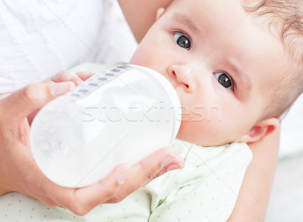 Charming mother feeding her adorable son in the kitchen at home Stock photo © wavebreak_media