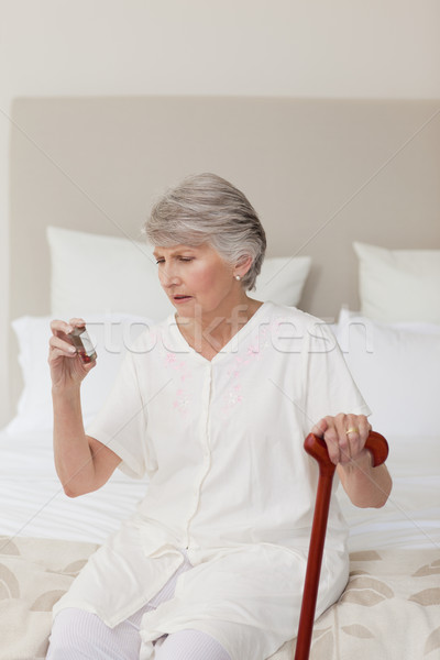 Sick senior woman taking her pills at home Stock photo © wavebreak_media