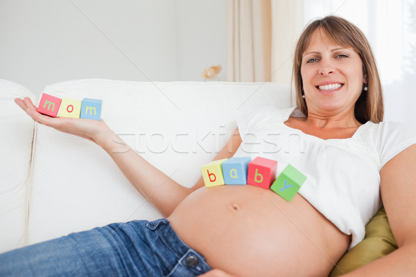 Attractive pregnant woman chilling out with toys in her living room Stock photo © wavebreak_media