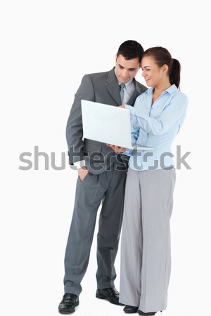 Business partner looking at a notebook together against a white background Stock photo © wavebreak_media