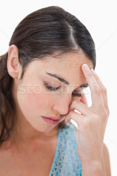 Stock photo: Portrait of a tired woman against a white background
