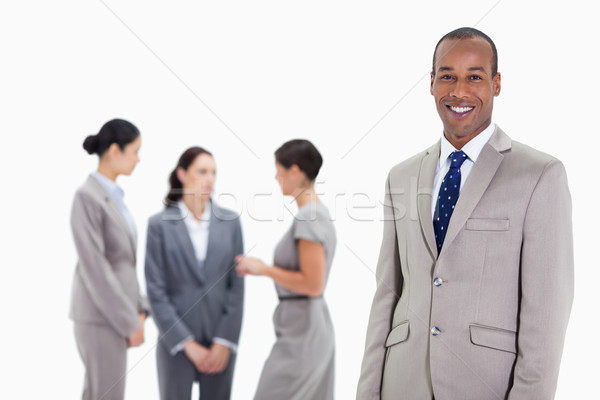 Close-up of a businessman smiling with three female co-workers talking seriously in the background Stock photo © wavebreak_media