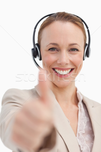 Portrait of a businesswoman with a headset approving against white background Stock photo © wavebreak_media