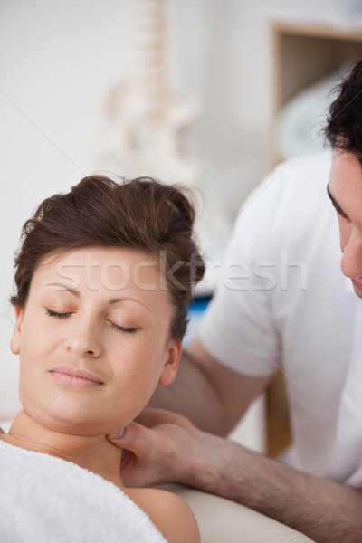 Woman being massaging her head while raising it in a room Stock photo © wavebreak_media