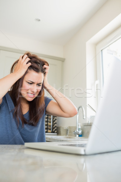 Angry woman with laptop in kitchen Stock photo © wavebreak_media