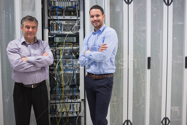 Two smiling men standing in front of servers in data center Stock photo © wavebreak_media