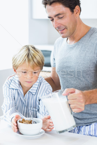 Father pouring milk onto sons cereal Stock photo © wavebreak_media