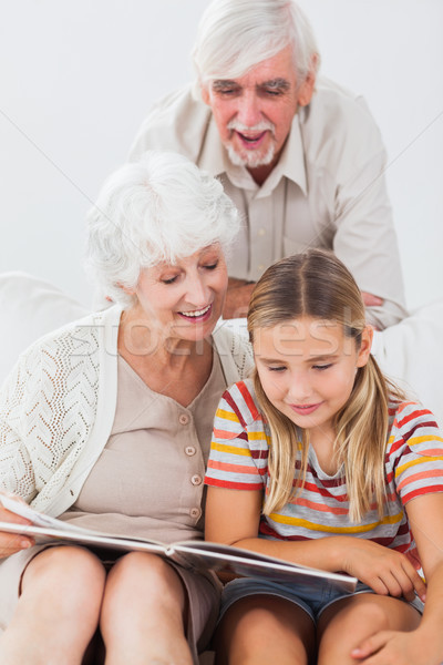 Сток-фото: улыбаясь · девушки · чтение · дедушка · и · бабушка · диване · книга