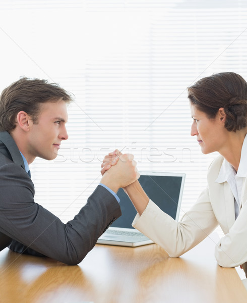 Business couple arm wrestling at office desk Stock photo © wavebreak_media