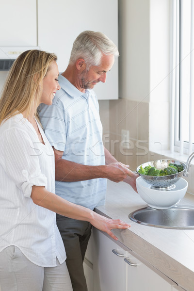 Couple rinsing vegetables at the sink Stock photo © wavebreak_media