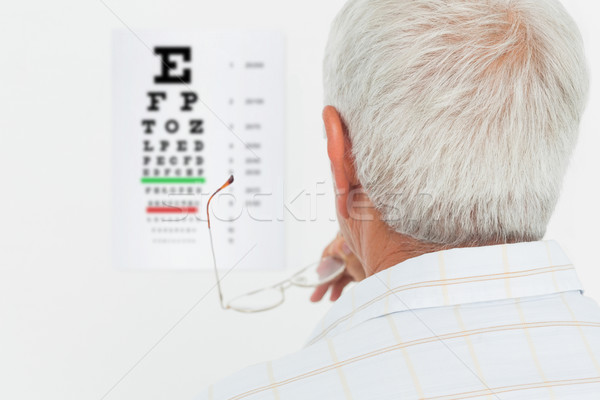 Rear view of a senior man looking at eye chart Stock photo © wavebreak_media