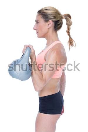 Female blonde crossfitter lifting kettlebell  Stock photo © wavebreak_media