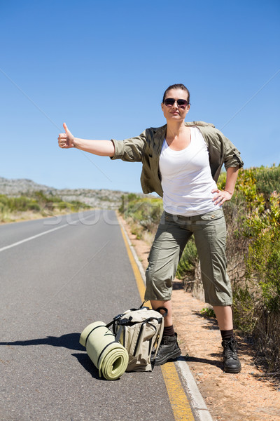 Pretty hitchhiker sticking thumb out on the road Stock photo © wavebreak_media