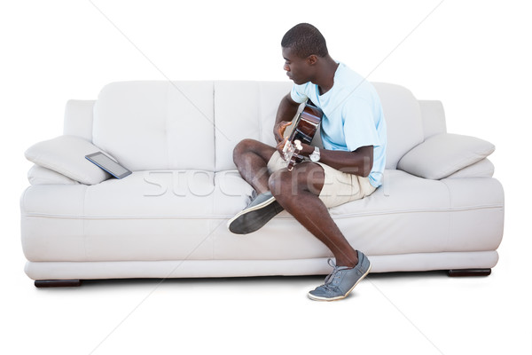 Homem sessão sofá aprendizagem jogar guitarra Foto stock © wavebreak_media