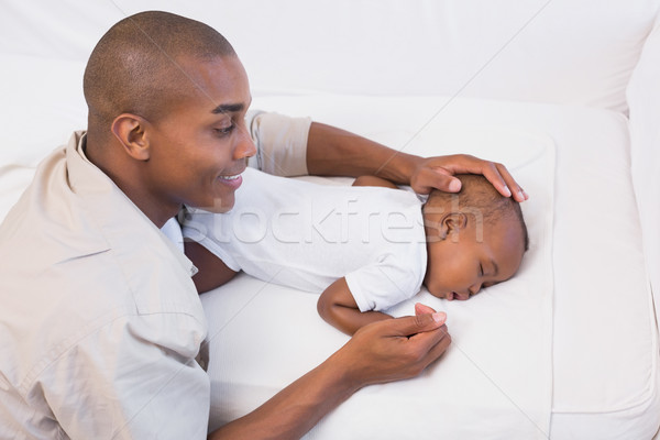 Adorable baby boy sleeping while being watched by father Stock photo © wavebreak_media