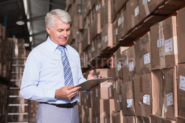 Stock photo: Warehouse manager checking his inventory