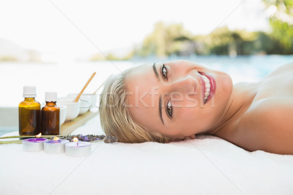 Beautiful woman lying on massage table at spa center Stock photo © wavebreak_media