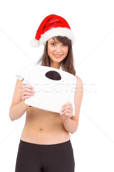 Festive fit brunette holding a weighing scales Stock photo © wavebreak_media