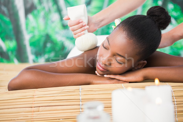 Pretty woman enjoying a herbal compress massage Stock photo © wavebreak_media