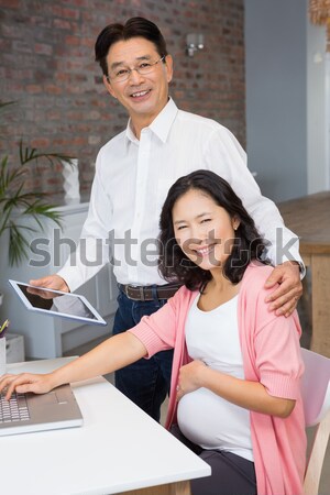 Pretty brunette picking out hair colour with stylist Stock photo © wavebreak_media