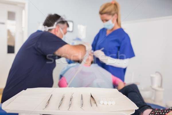 Dentist and his dental assistant examining a young patient Stock photo © wavebreak_media