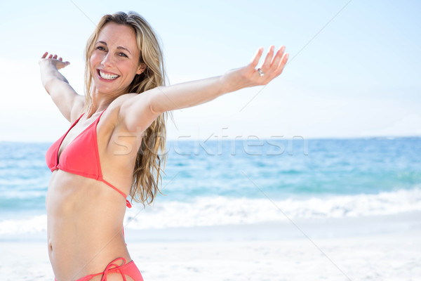 Smiling blonde in bikini looking at camera arms outstretched Stock photo © wavebreak_media